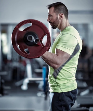 man curling bent bar stock image