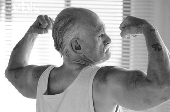 older man reverse double bicep black and white stock image