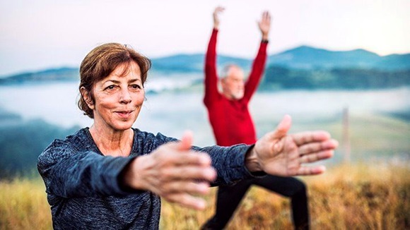 older couple exercising outdoors stock image