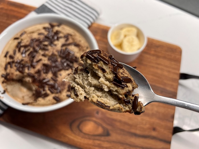 nzprotein baked protein oats in a bowl with tea towel and choc chips