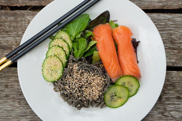 black bean japanese salad on white plate with chopsticks