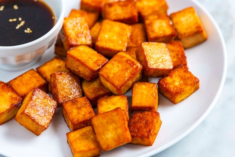 fried tofu blocks on a white plate