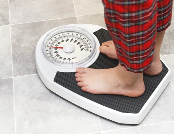 person standing on weight scales stock image