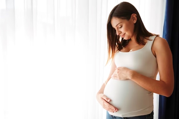 woman holding her pregnant stomach stock image