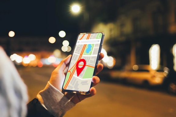 person holding phone with maps on screen stock image