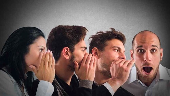 group of people whispering in each others ear stock image