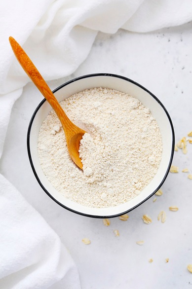 coconut flour in a bowl with wooden spoon