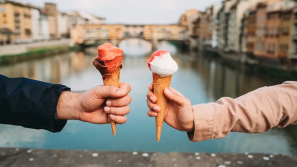 couple holding ice creams water background stock image