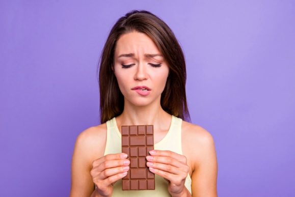 woman holding a large block of chocolate stock image