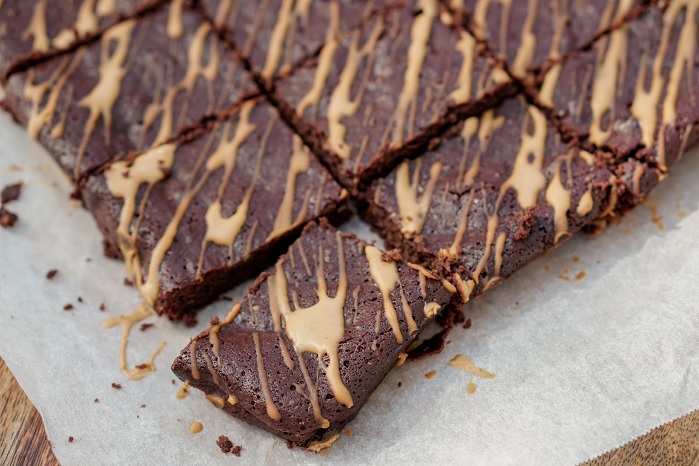 dark chocolate protein brownie drizzled with powdered peanut butter