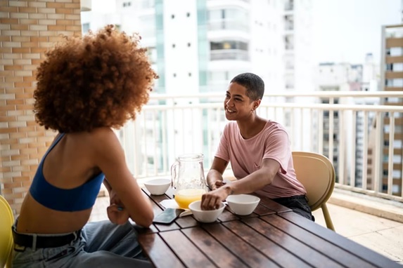 friends talking around a table stock image