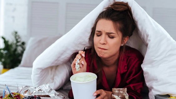 woman eating tub of ice cream stock image