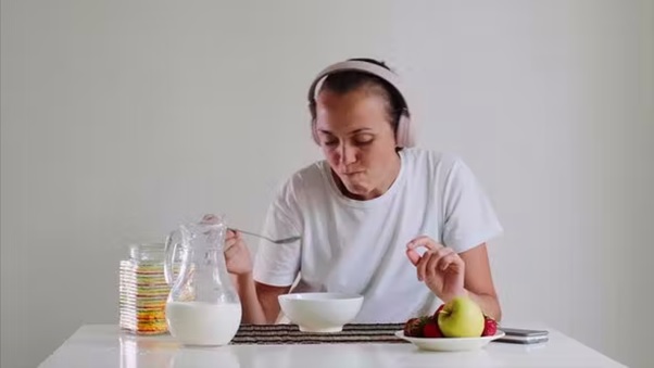 woman eating while listening to music stock image