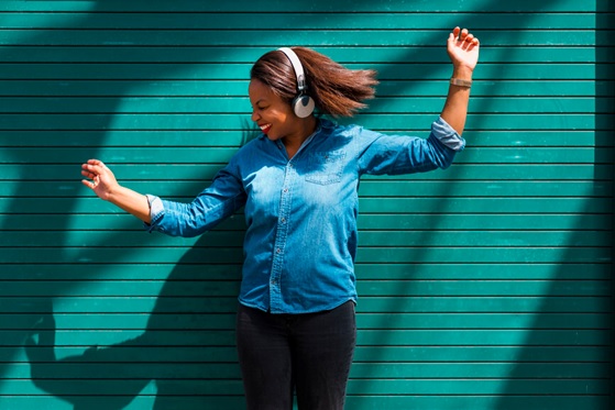 woman happy dancing with headphones stock image