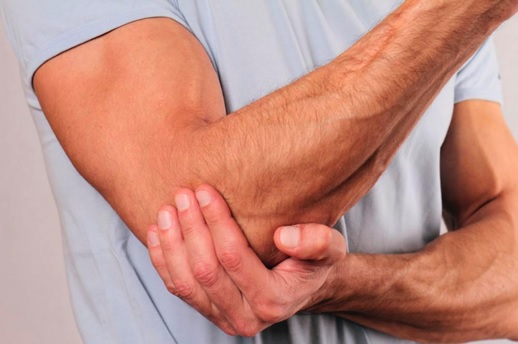 man clutching elbow stock image
