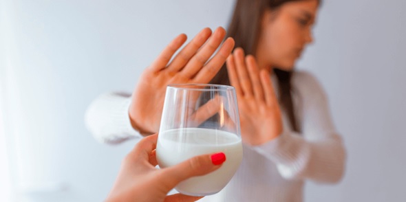 women refusing cup of milk stock image