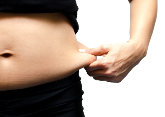 pinching stomach fat stock image