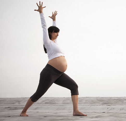 pregnant woman stretching stock image