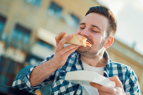 man eating a quiche stock image