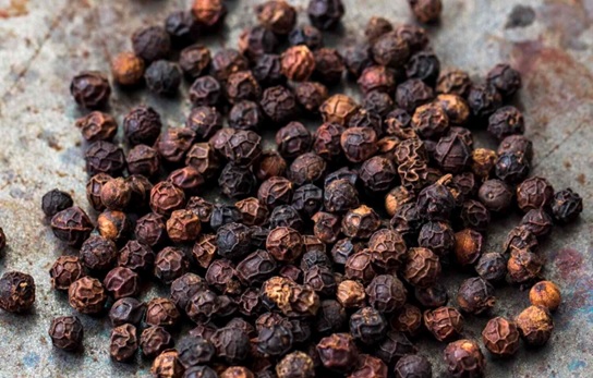 peppercorns spread out stock image