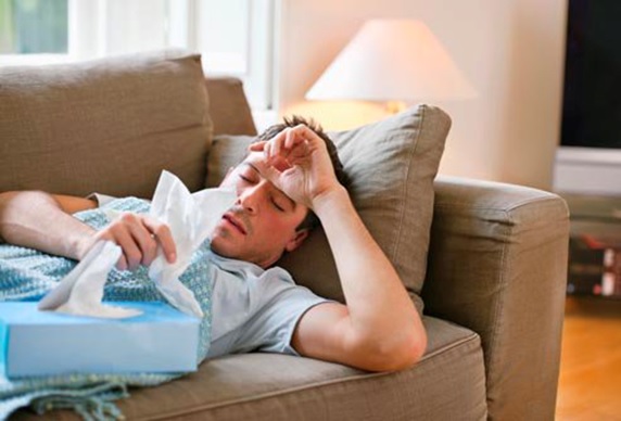 man with flu staying home resting stock image