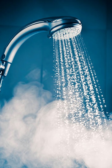 shower head and hot water stock image