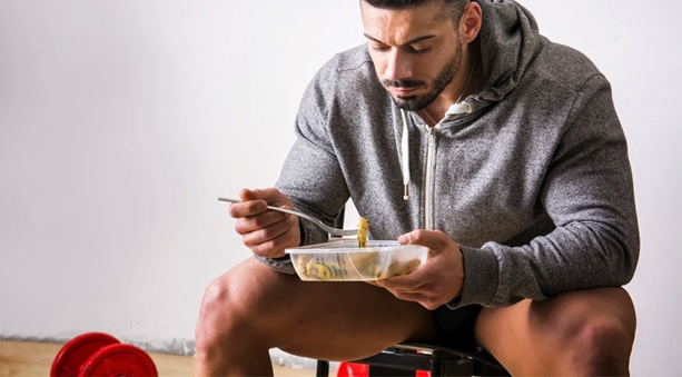 fit man eating a meal stock image