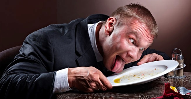 man licking his plate clean stock image