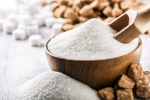 sugar in a bowl with wooden spoon stock image