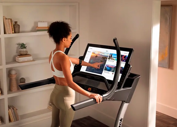 woman on a treadmill at home stock image