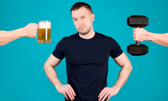 man and arms holding out beer and dumbell