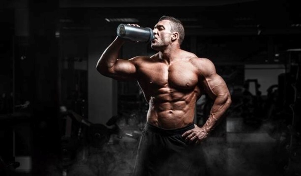 large muscle man drinking from a shaker bottle no shirt stock image