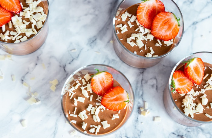 jars of protein mousse with berries and white chocolate aerial view