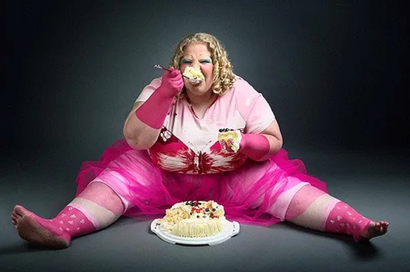 large woman eating cake stock image