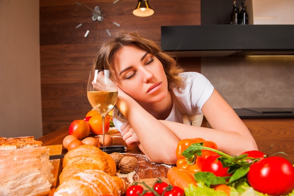 woman asleep at the table with food stock image