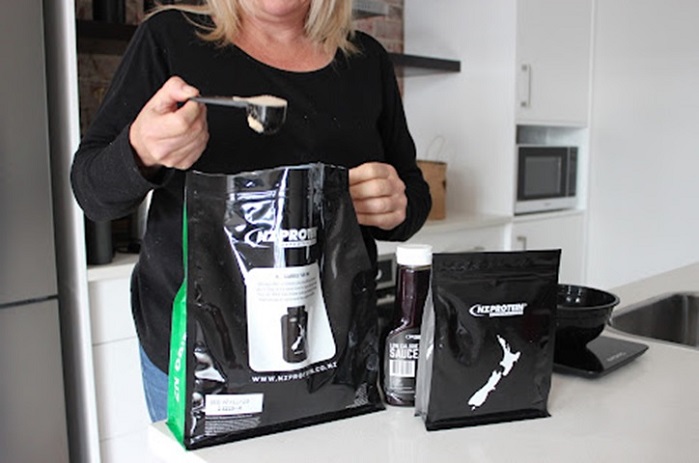 woman with bag of protein powder