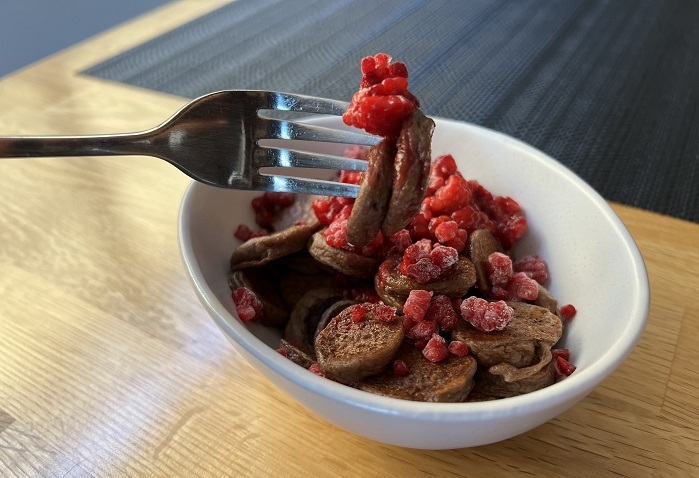 mini protein pancakes with raspberries in a bowl