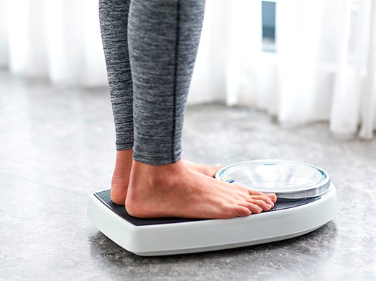 woman standing on scales stock image