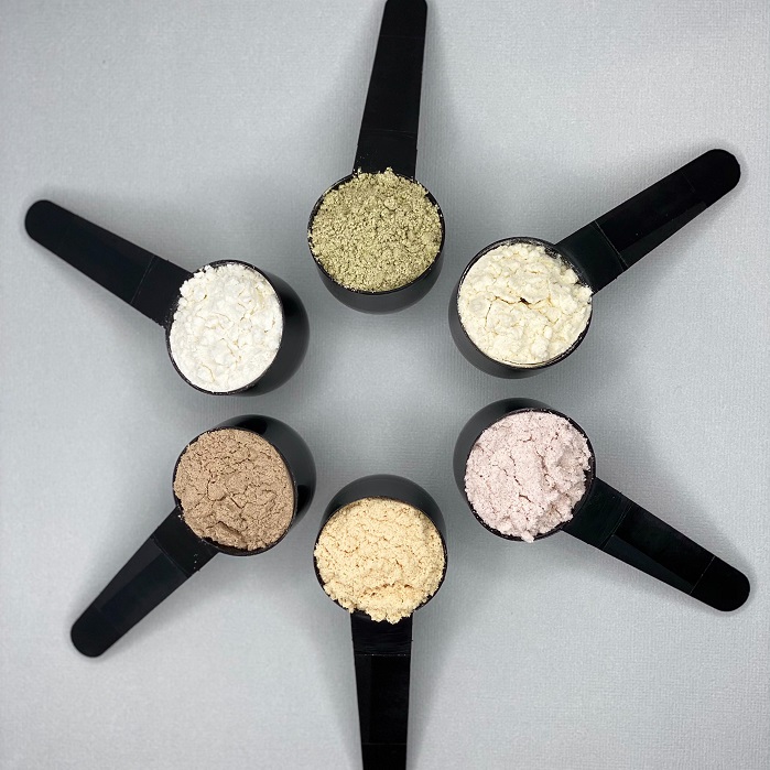 various protein powders in scoops round shape