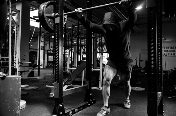 man in squat rack stock image