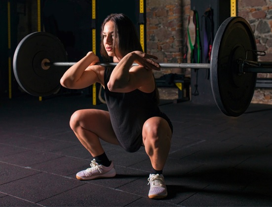 woman doing front squats barbell stock image