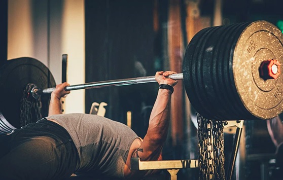 man bench pressing large weight stock image