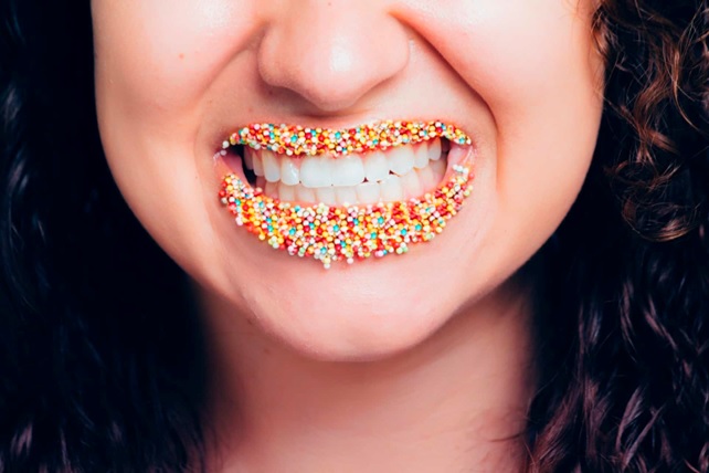 woman with sugary foods around her mouth stock image