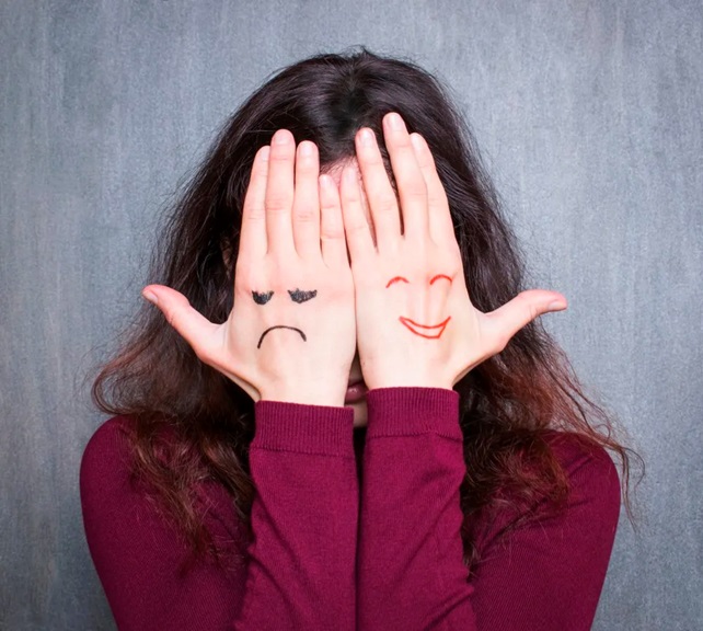 woman with happy and sad hands stock image