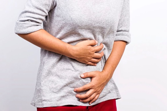 person clutching their stomach stock image