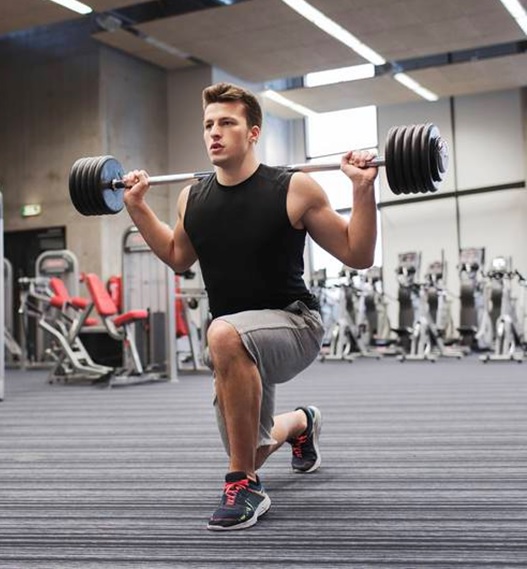 man in the gym doing fitness squats stock image