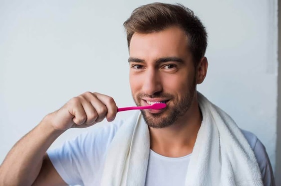 man brushing his teeth stock image