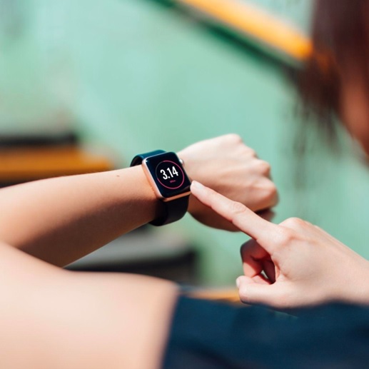 woman looking at a fitness watch on her wrist stock image