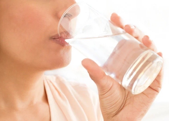 woman drinking cup of water