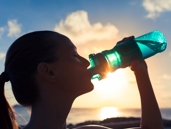 woman drinking from a drink bottle stock image